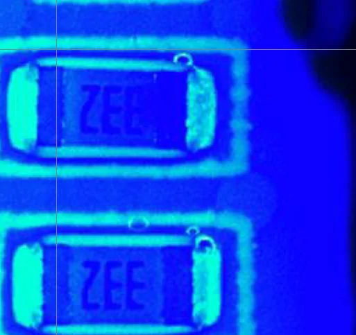 Conformal coating on board components imaged under UV lighting
